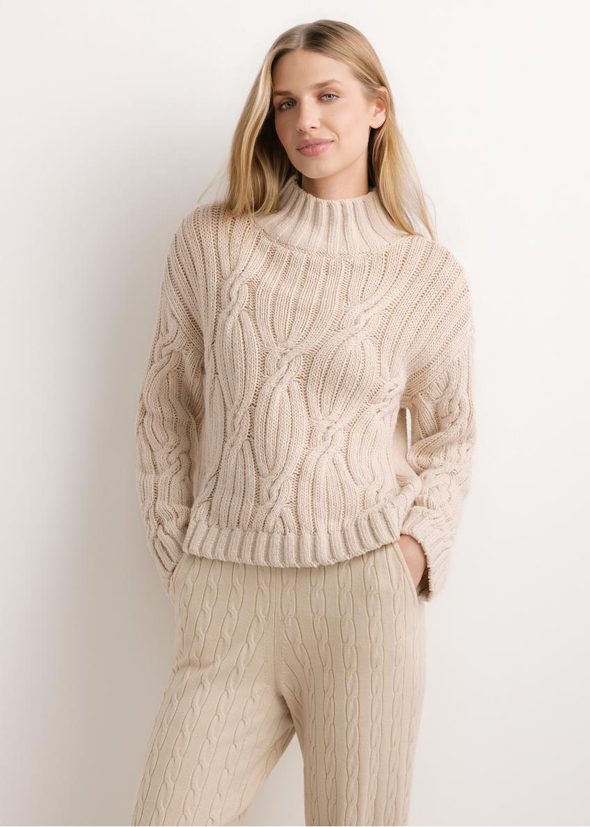 Damski sweter oversize w jasnobeżowym kolorze SWEDT-0278-1A(Z26), widok produktu od przodu na modelce. Widoczna połowa sylwetki.